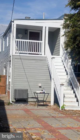a view of a house with wooden deck