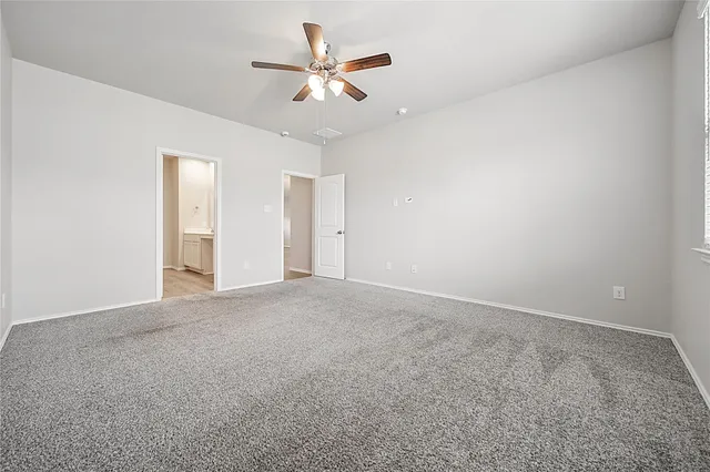 a spacious bathroom with a double vanity sink and mirror