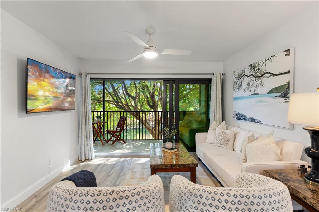 600 Neapolitan Way, Unit 257 Naples, FL 34103 - Photo 1 of 35 a living room with furniture and a large window