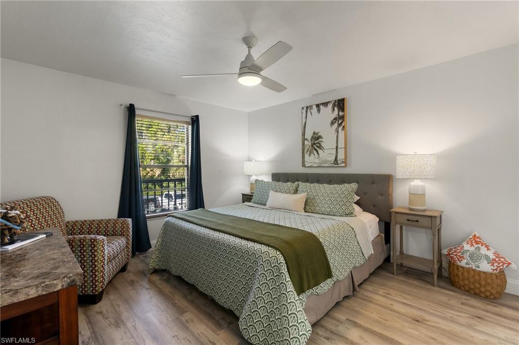 600 Neapolitan Way, Unit 257 Naples, FL 34103 - Photo 12 of 35 a bedroom with a bed couch and a window