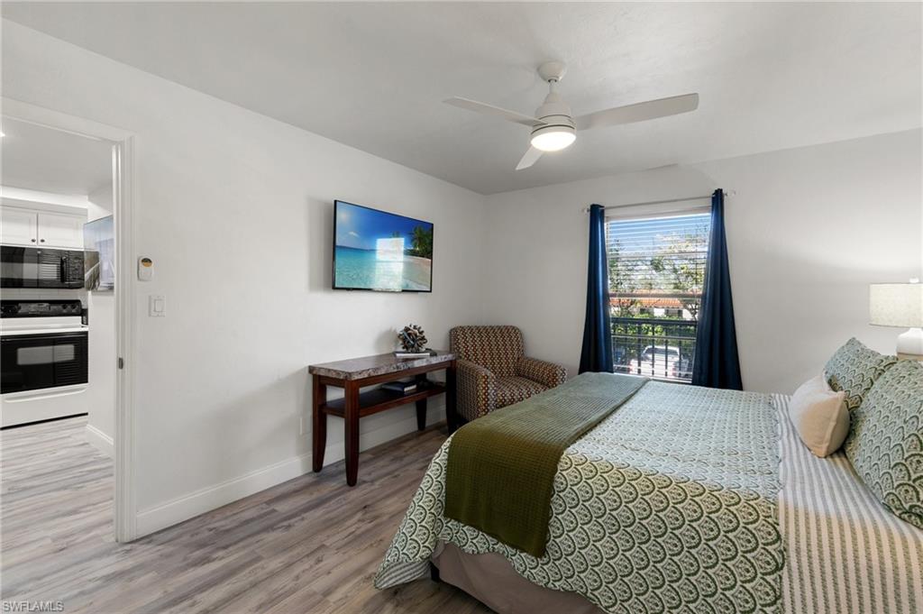 600 Neapolitan Way, Unit 257 Naples, FL 34103 - Photo 13 of 35 a bedroom with a bed and a table
