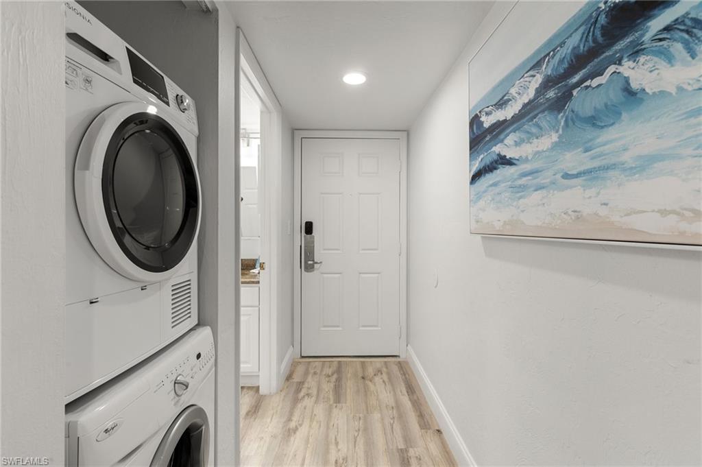 600 Neapolitan Way, Unit 257 Naples, FL 34103 - Photo 17 of 35 a view of a hallway with washer and dryer