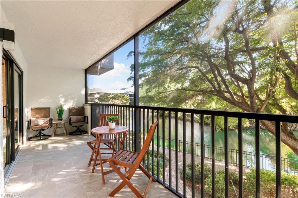 600 Neapolitan Way, Unit 257 Naples, FL 34103 - Photo 18 of 35 a view of a two chairs in the balcony