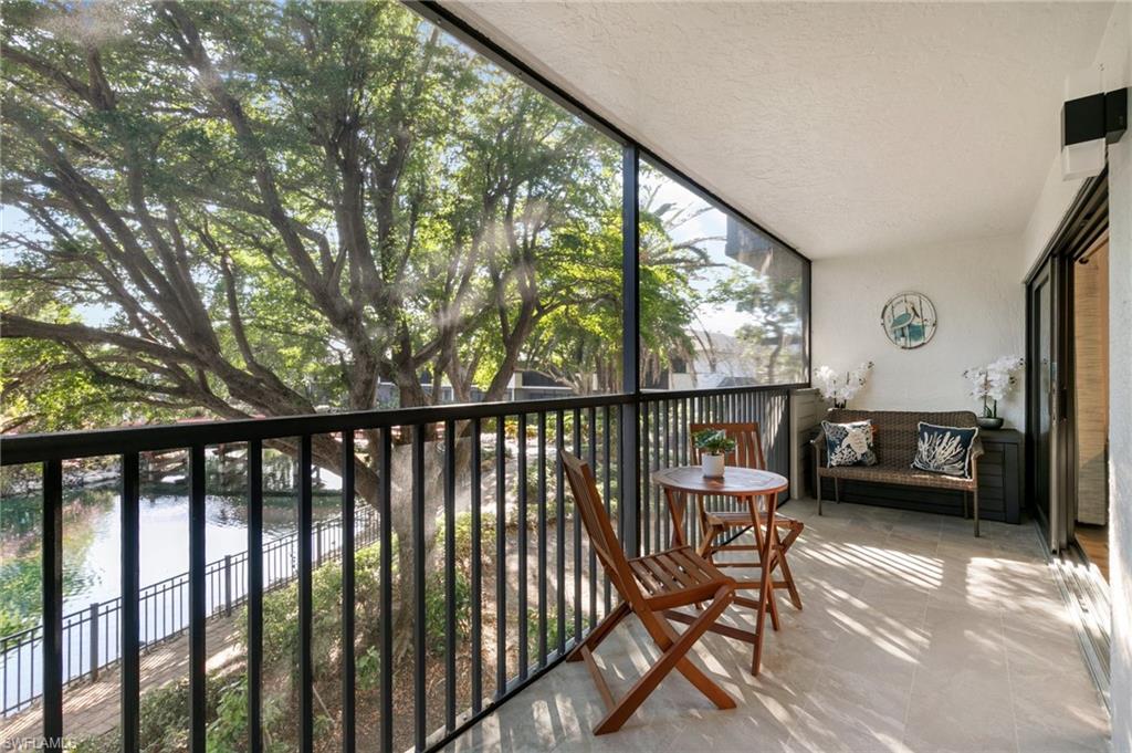 600 Neapolitan Way, Unit 257 Naples, FL 34103 - Photo 19 of 35 a view of a two chairs in the balcony