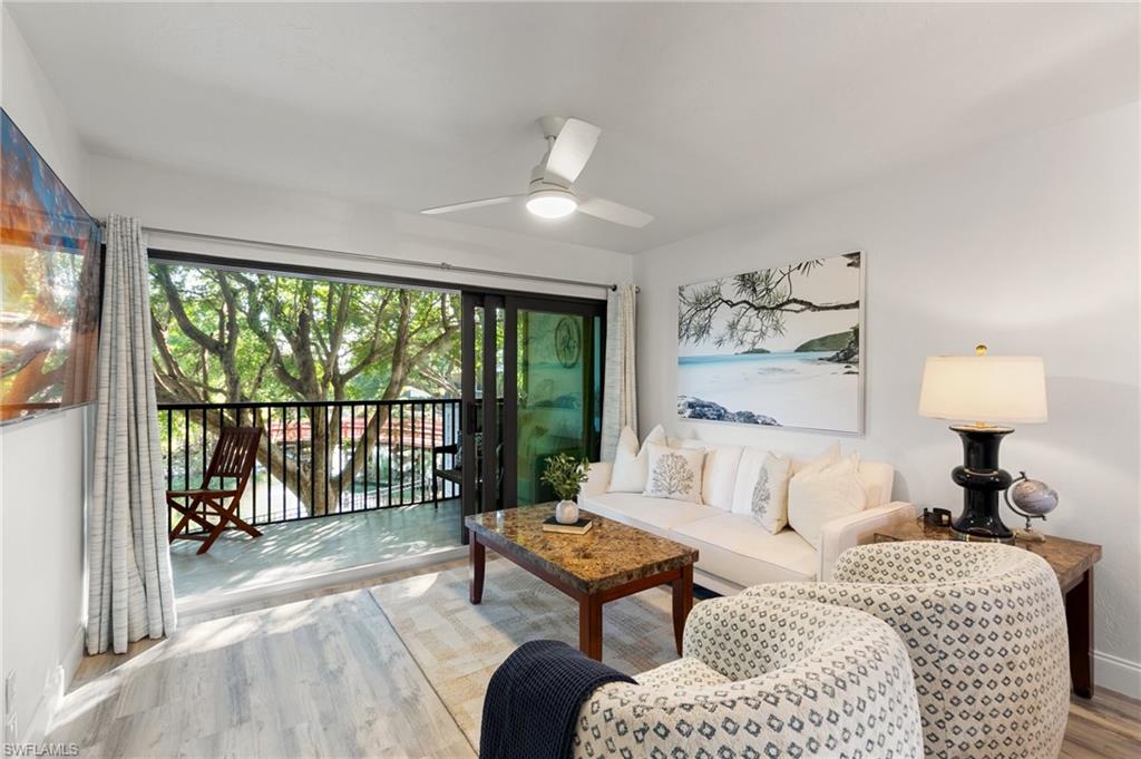 600 Neapolitan Way, Unit 257 Naples, FL 34103 - Photo 5 of 35 a spacious bedroom with a bed and a couch
