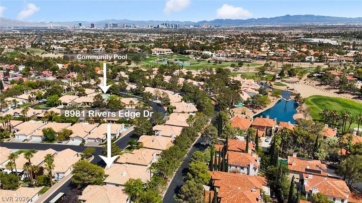 8981 Rivers Edge Drive Las Vegas, NV 89117 - Photo 57 of 69 An aerial perspective reveals a vibrant community with lush landscaping and easy access to a refreshing community pool.