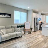 a living room with furniture and kitchen view