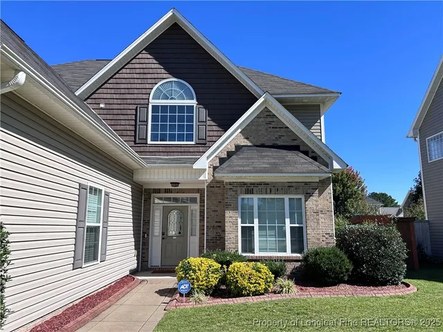 a front view of a house with a yard