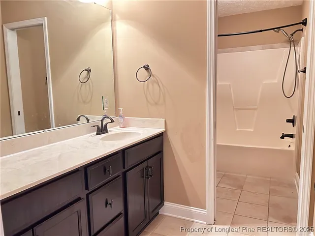 a bathroom with a double vanity sink a mirror and a shower