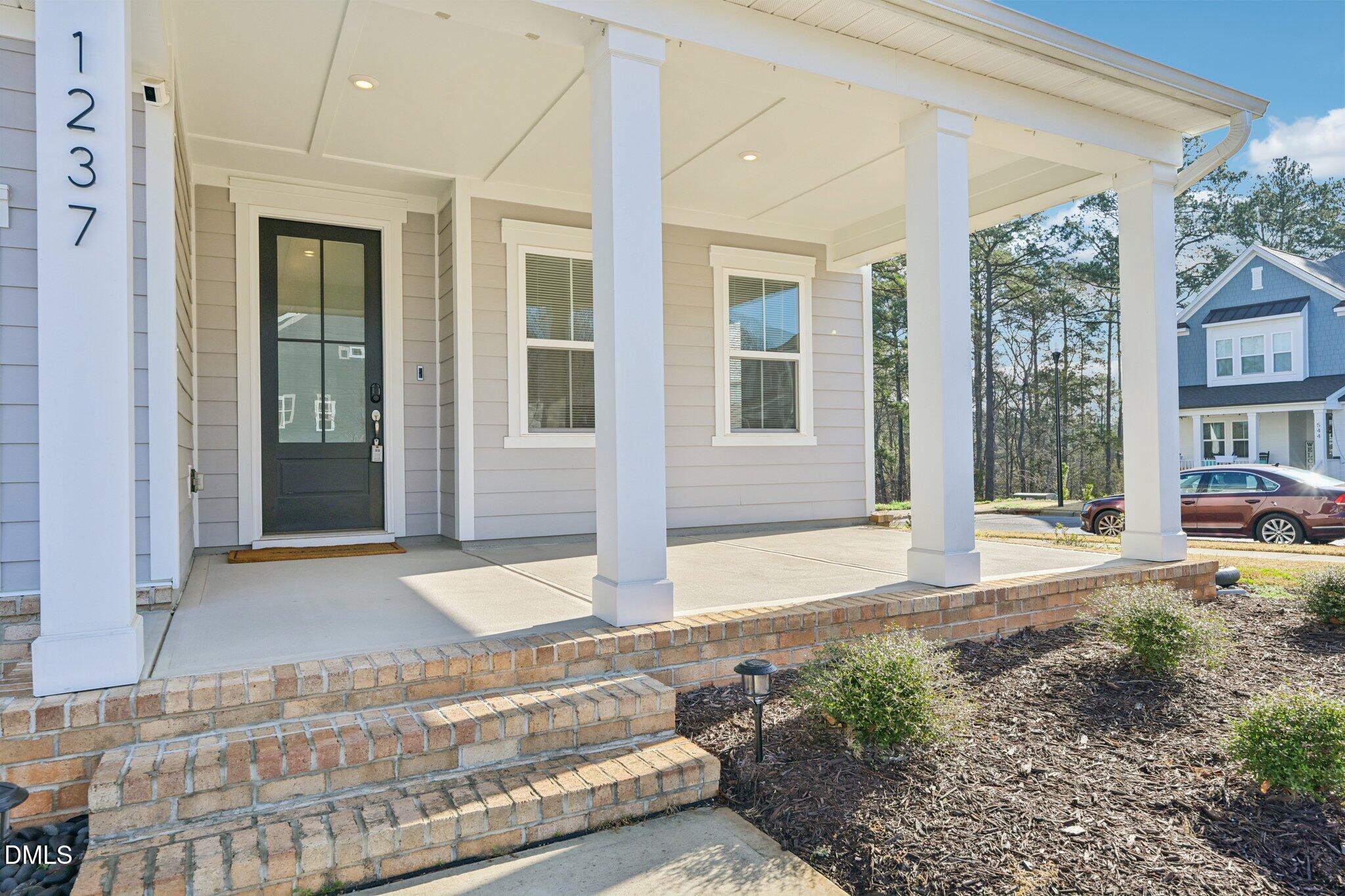 1237 Remey Avenue Wake Forest, NC 27587 - Photo 2 of 40 a view of a brick house with many windows