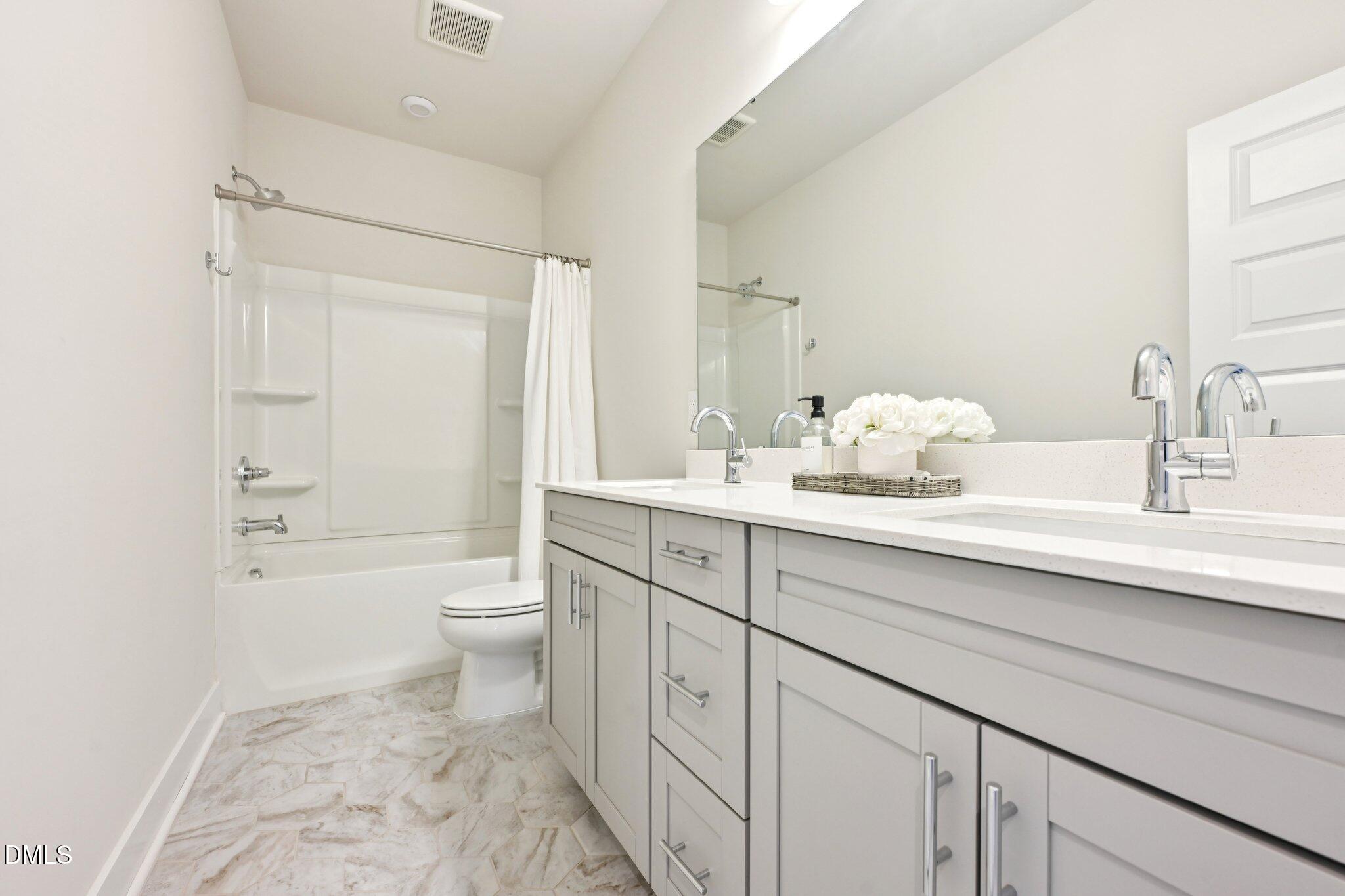 1237 Remey Avenue Wake Forest, NC 27587 - Photo 29 of 40 a bathroom with a sink a toilet and shower