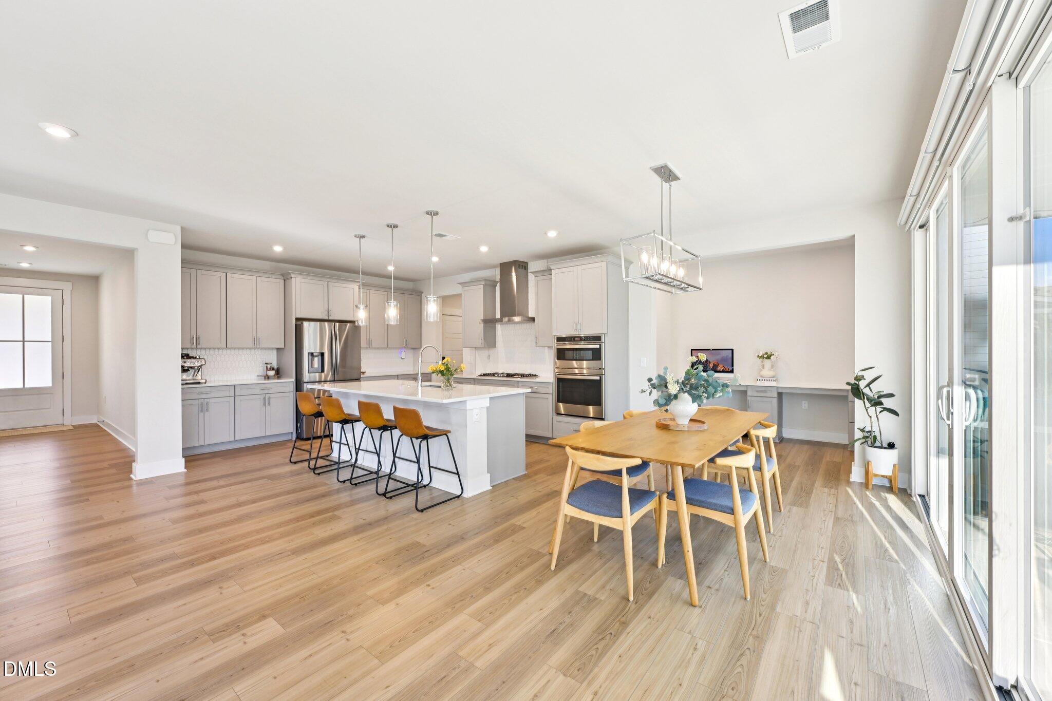 1237 Remey Avenue Wake Forest, NC 27587 - Photo 5 of 40 a view of a dining room with furniture and wooden floor