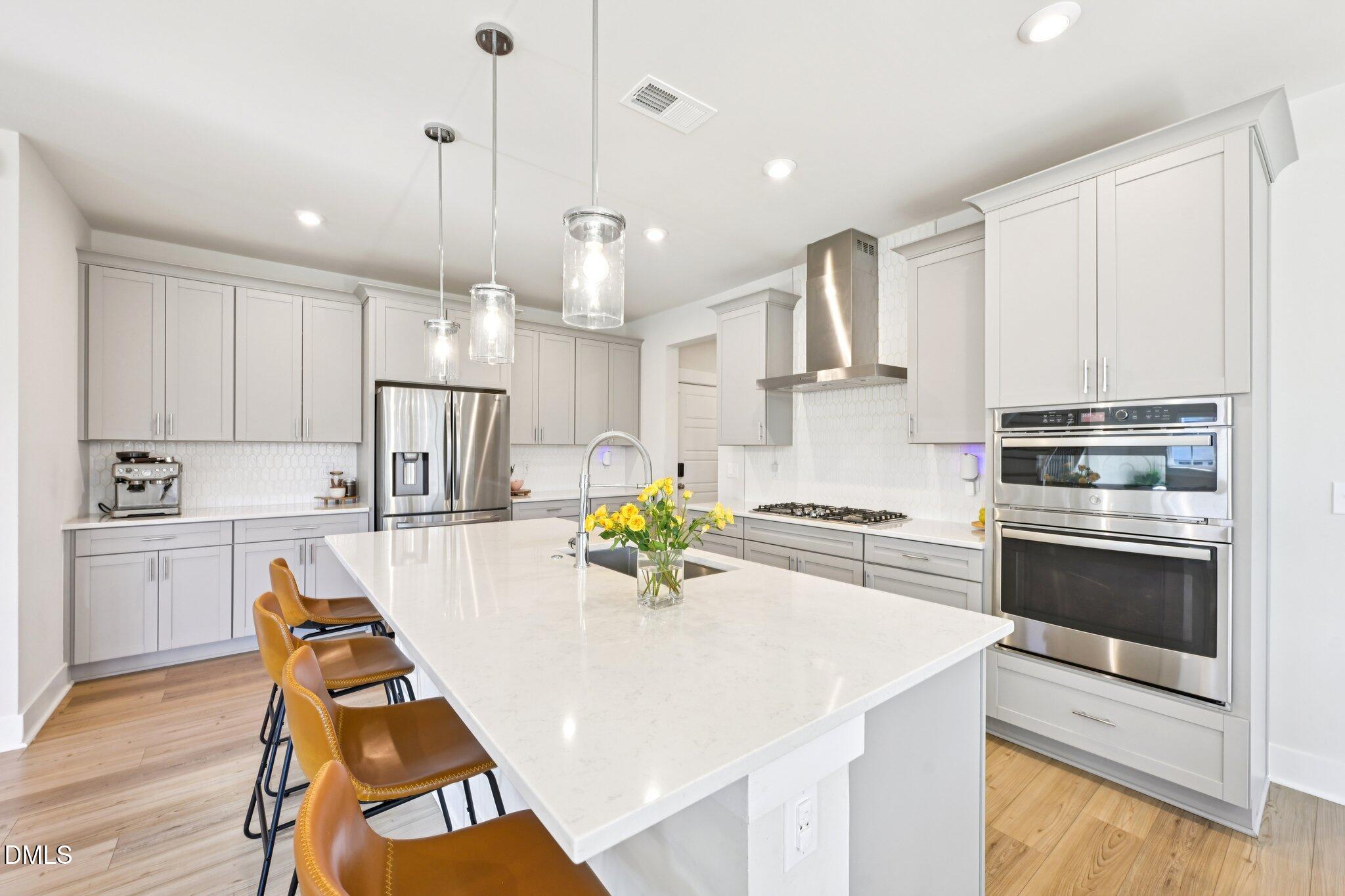 1237 Remey Avenue Wake Forest, NC 27587 - Photo 10 of 40 a kitchen with kitchen island a counter space a sink appliances and cabinets