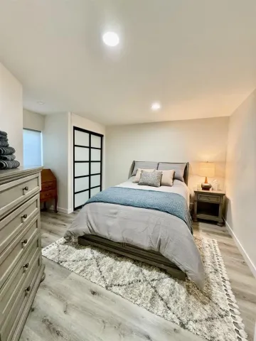a bedroom with a bed and a dresser