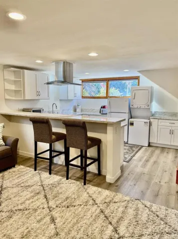 a kitchen with stainless steel appliances kitchen island granite countertop a sink and cabinets