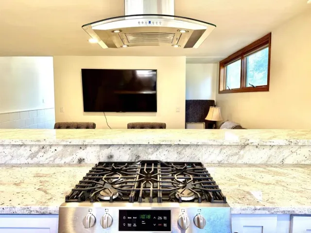 a kitchen with a stove and a white cabinet
