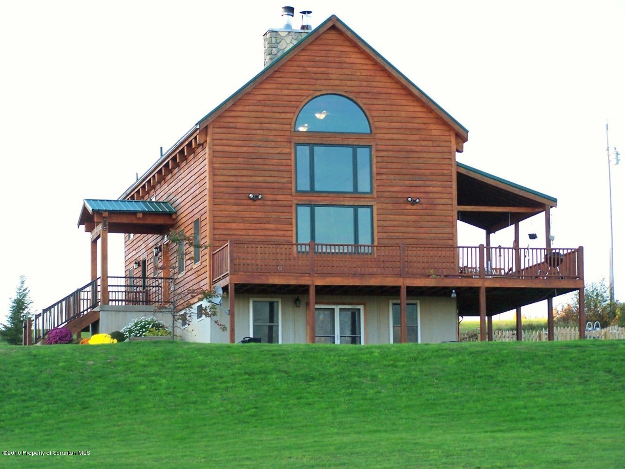 1018 Rattlesnake Hill Road Meshoppen, PA 18630 - Photo 2 of 26 a front view of a house with a garden