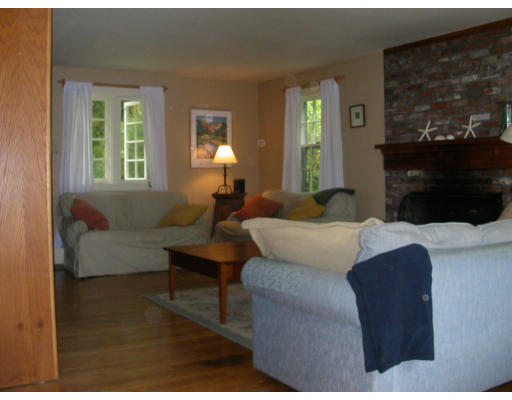 302 Red Acre Road Stow, MA 01775 - Photo 3 of 6 a bedroom with a bed window and couch