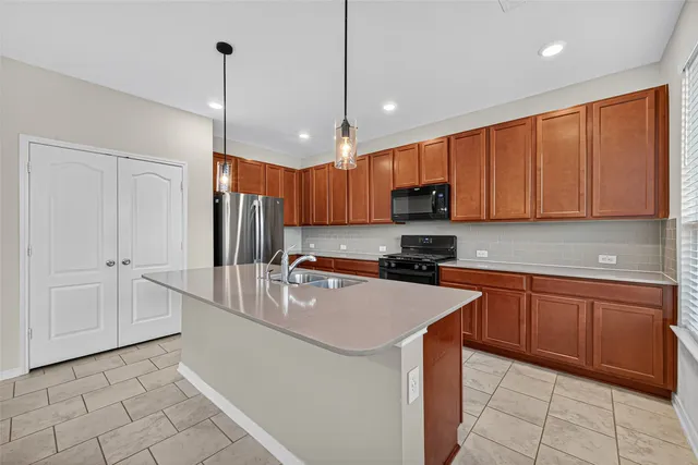a kitchen with stainless steel appliances a refrigerator sink and microwave
