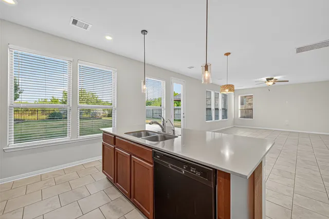 a kitchen with kitchen island a sink a counter and a large window