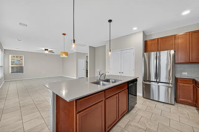 a kitchen with kitchen island granite countertop a sink appliances and cabinets