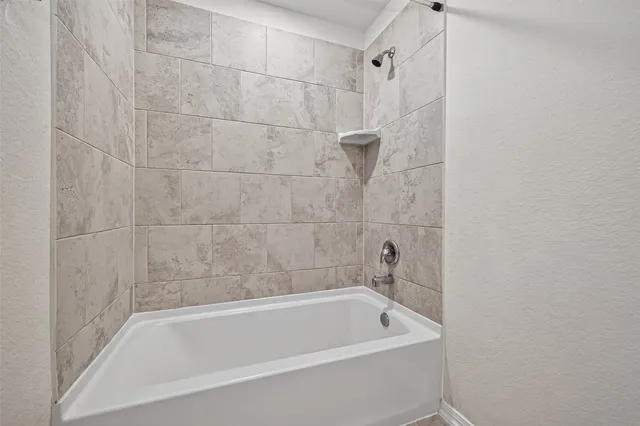 a bath tub sitting next to a shower