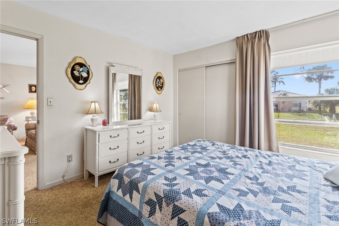 1609 Ridgecrest Street Lehigh Acres, FL 33936 - Photo 11 of 20 a bedroom with a bed and a dresser in it