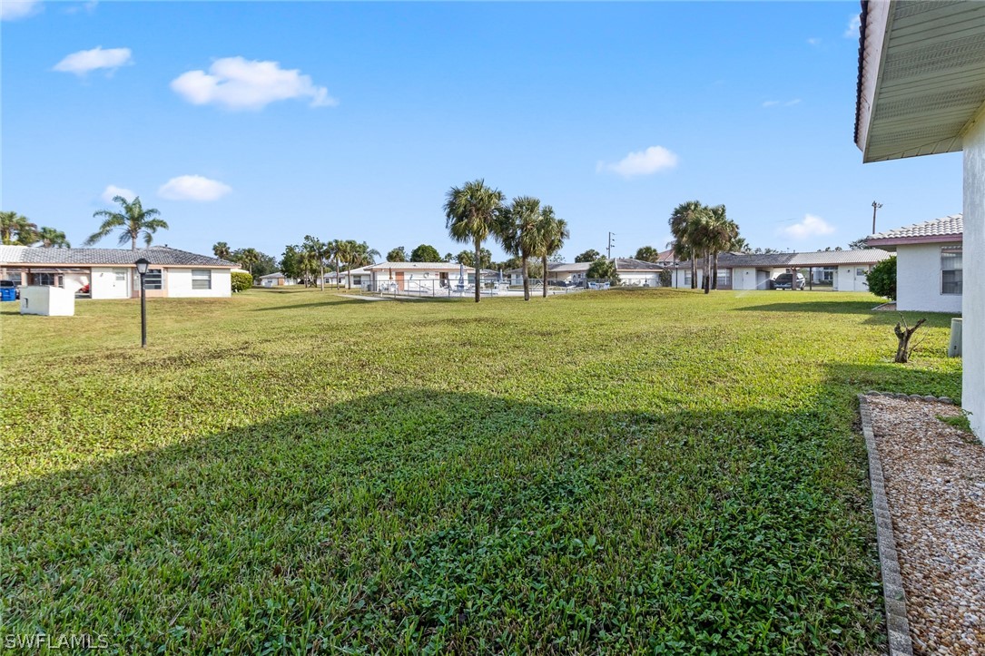 1609 Ridgecrest Street Lehigh Acres, FL 33936 - Photo 20 of 20 a view of a golf course with a lake