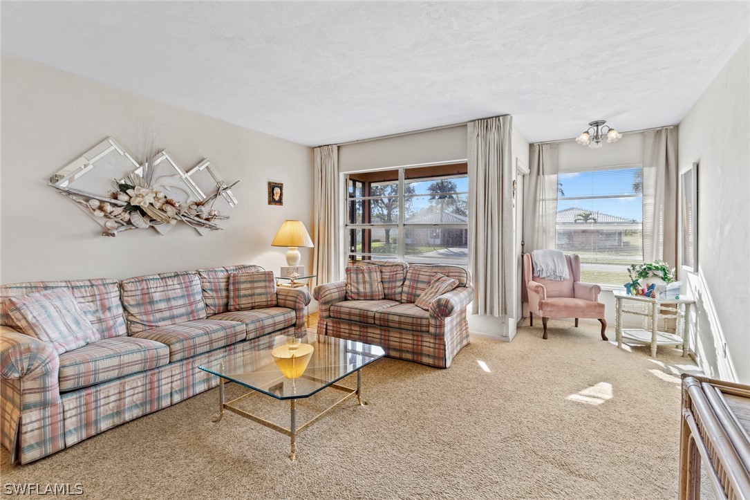 1609 Ridgecrest Street Lehigh Acres, FL 33936 - Photo 3 of 20 a living room with furniture and a large window