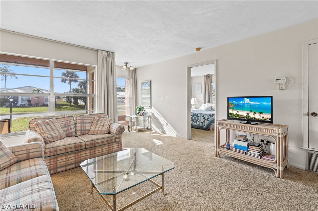 1609 Ridgecrest Street Lehigh Acres, FL 33936 - Photo 4 of 20 a living room with furniture and a flat screen tv