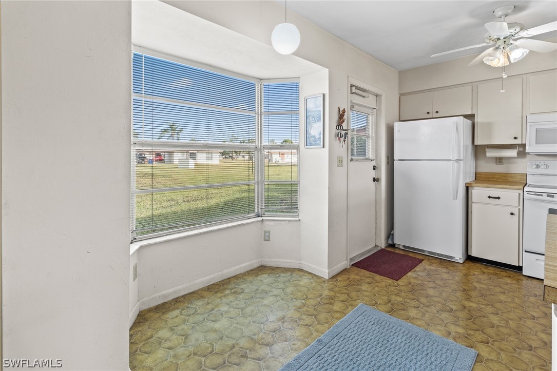 1609 Ridgecrest Street Lehigh Acres, FL 33936 - Photo 7 of 20 a view of a kitchen with a sink and dishwasher kitchen view with wooden floor