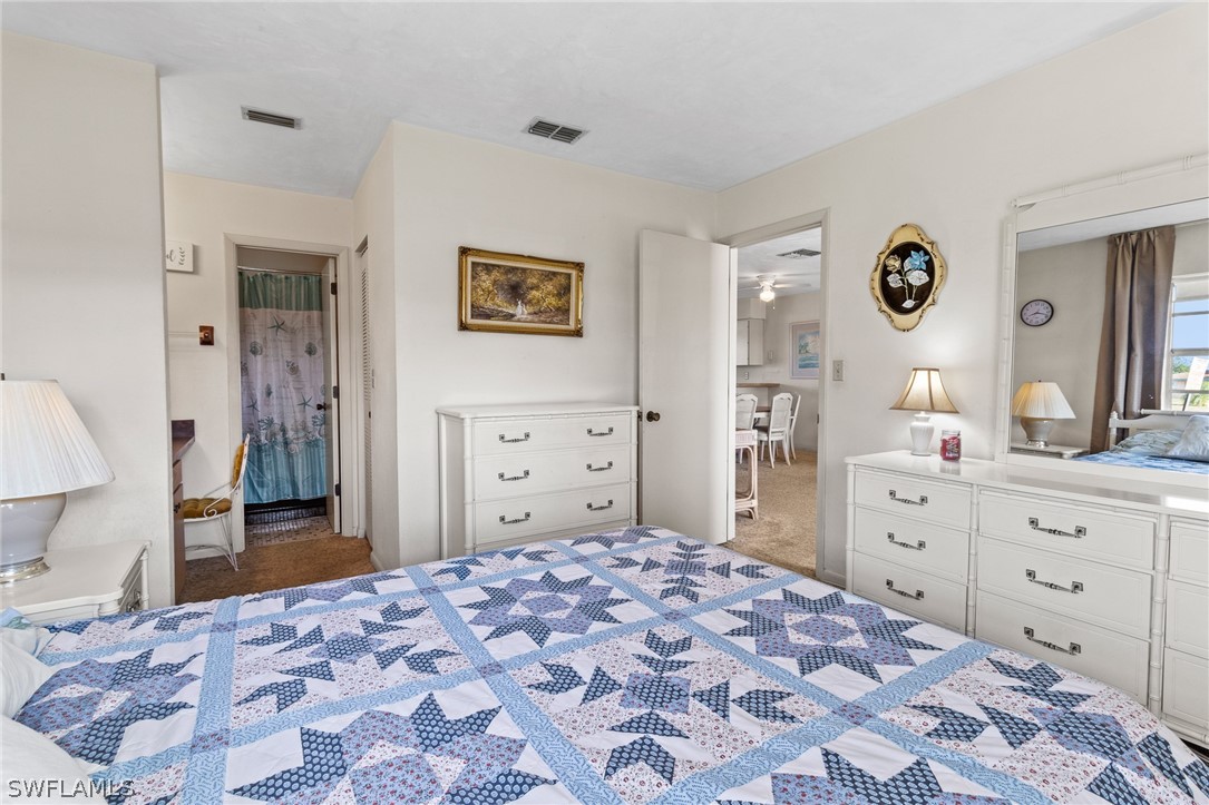1609 Ridgecrest Street Lehigh Acres, FL 33936 - Photo 10 of 20 a bedroom with a bed and a dresser in it