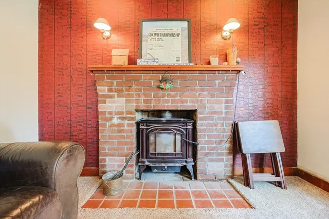 a fireplace with a table and chairs
