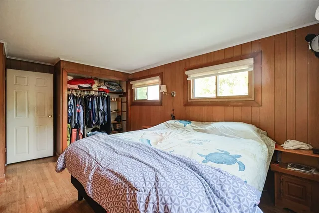 a bed sitting in a bedroom next to a window