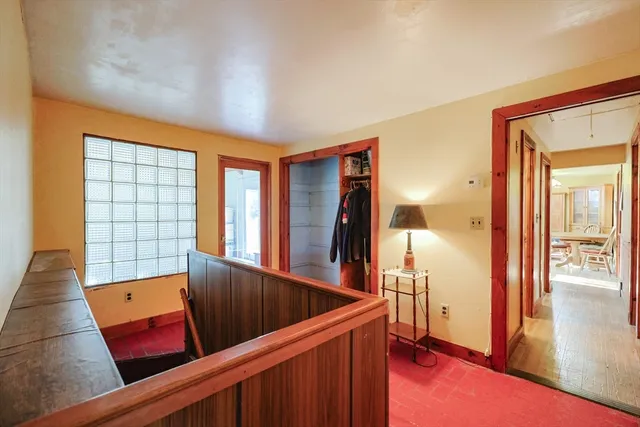 a view of a living room with furniture and wooden floor