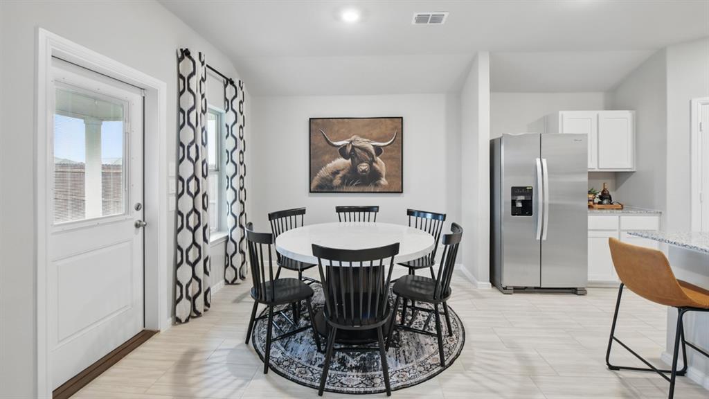 1505 Cansler Drive Krum, TX 76249 - Photo 9 of 39 a dining room with furniture and window