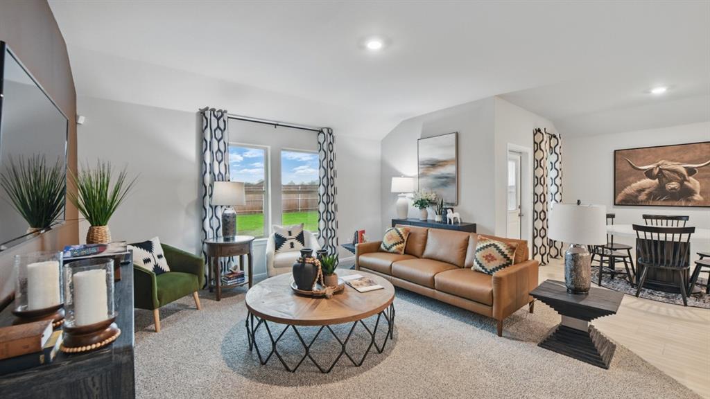 1505 Cansler Drive Krum, TX 76249 - Photo 13 of 39 a living room with furniture a table and a potted plant