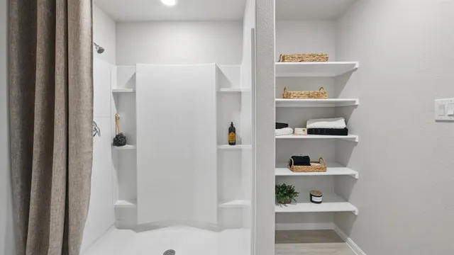 a bedroom with a bed and a large mirror on the dresser