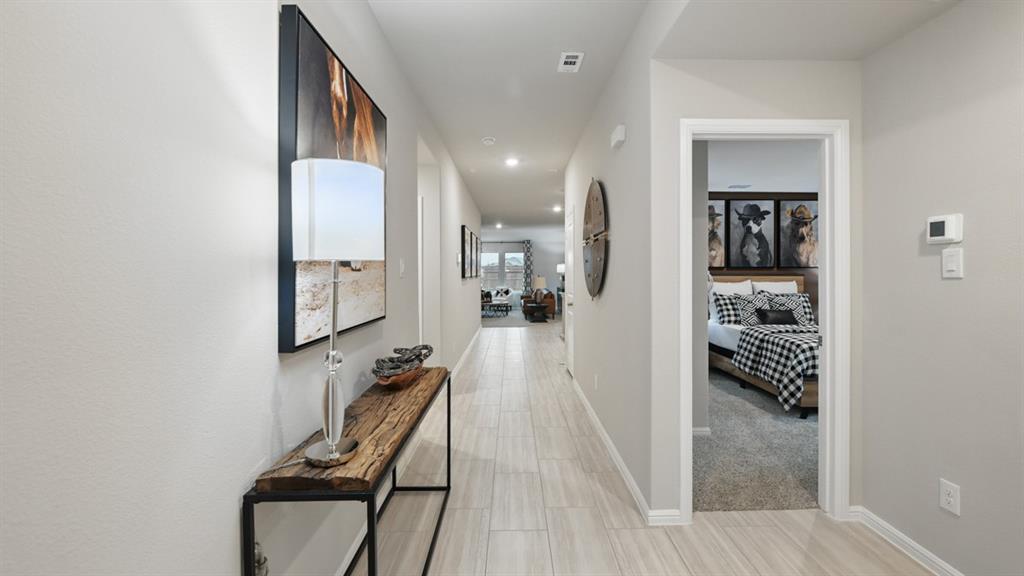 1505 Cansler Drive Krum, TX 76249 - Photo 23 of 39 a view of a hallway with wooden floor and a bathroom
