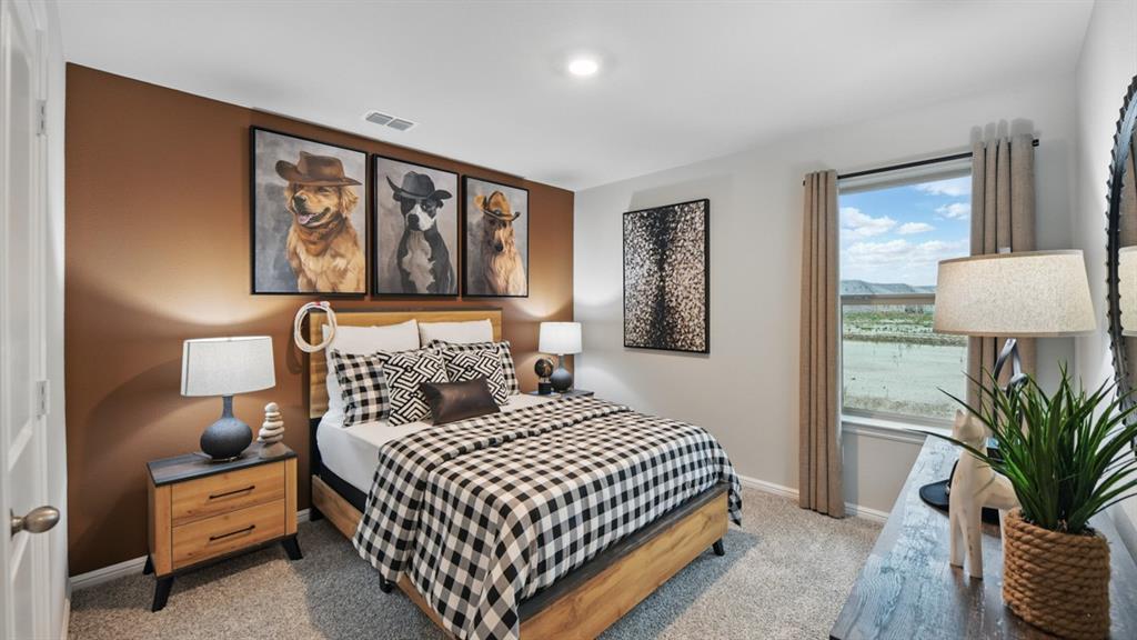 1505 Cansler Drive Krum, TX 76249 - Photo 24 of 39 a bedroom with a large bed and a window