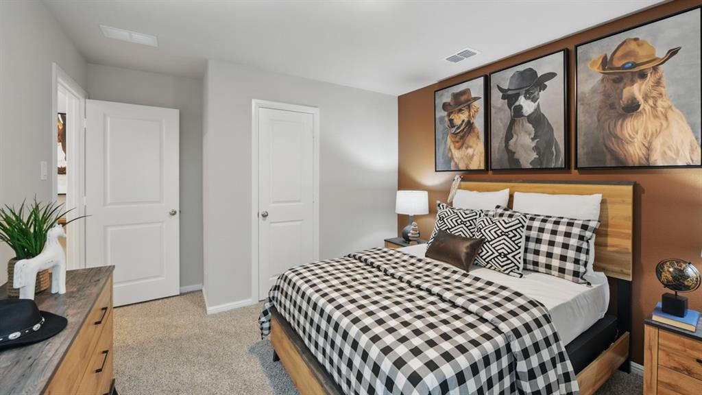 1505 Cansler Drive Krum, TX 76249 - Photo 25 of 39 a bedroom with a bed and painting on the wall
