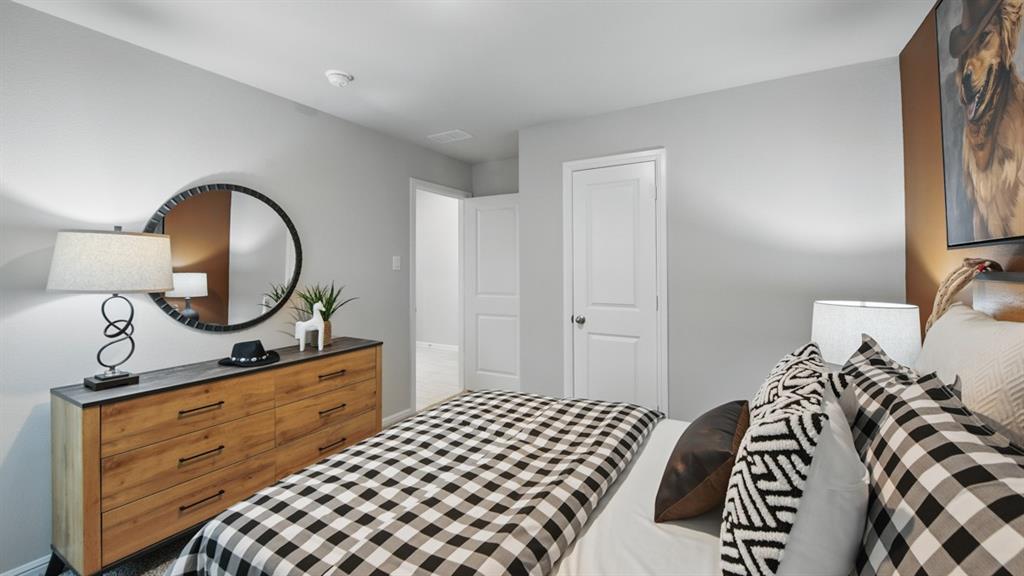 1505 Cansler Drive Krum, TX 76249 - Photo 26 of 39 a bedroom with a bed and a mirror on dresser