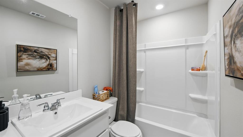 1505 Cansler Drive Krum, TX 76249 - Photo 27 of 39 a bathroom with a sink and a mirror