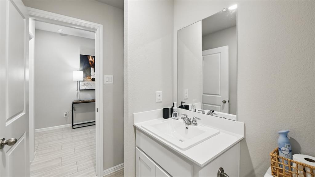 1505 Cansler Drive Krum, TX 76249 - Photo 28 of 39 a bathroom with a sink a mirror and a vanity