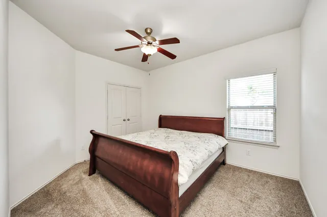 a bedroom with a bed and window