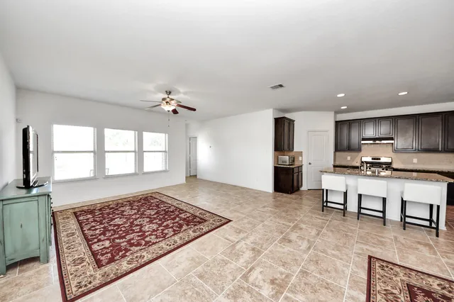 a living room with furniture and a rug