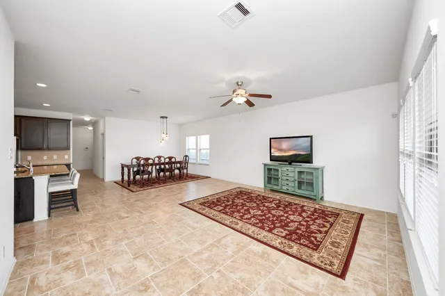 a living room with furniture rug and window