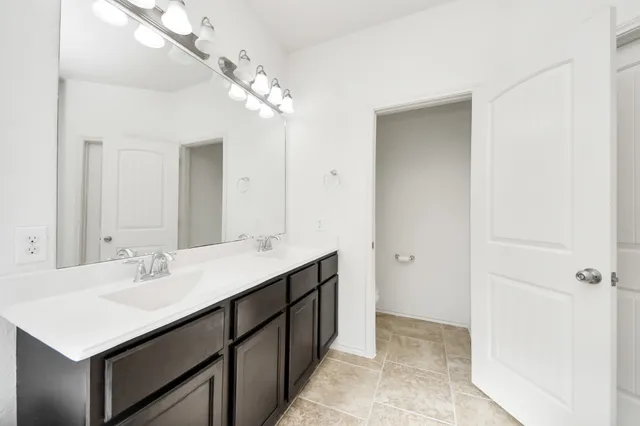 a bathroom with a sink double vanity and a mirror