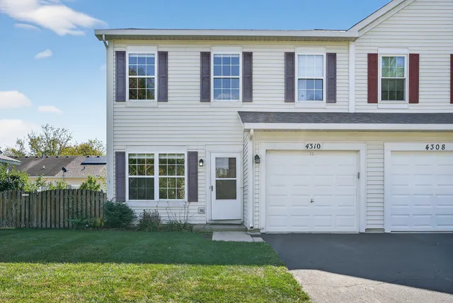 a view of a house with a garden and pathway