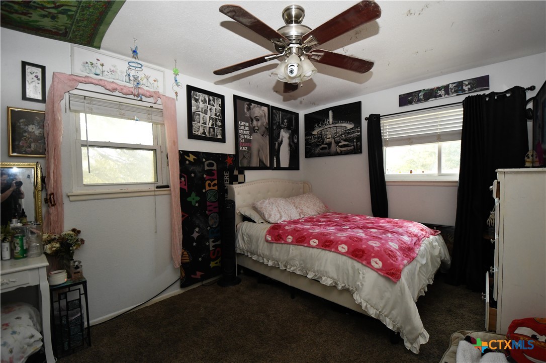 6019 Forest Ridge San Antonio, TX 78240 - Photo 16 of 25 a bedroom with a bed dresser and a window